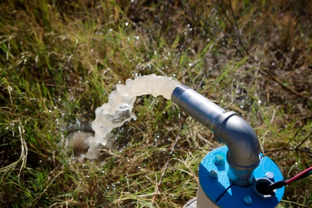 Well pump in operation pumping water